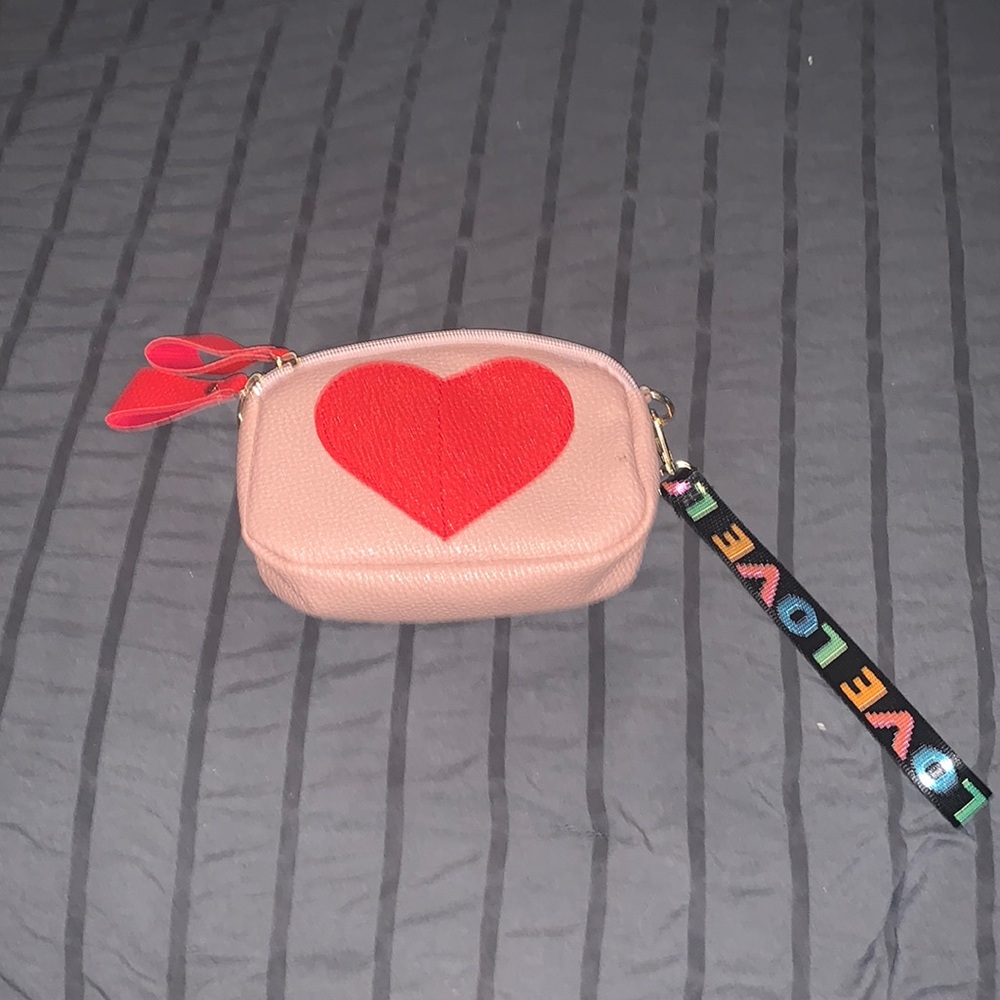 Wristlet pink with a red heart, and strap with the words love,